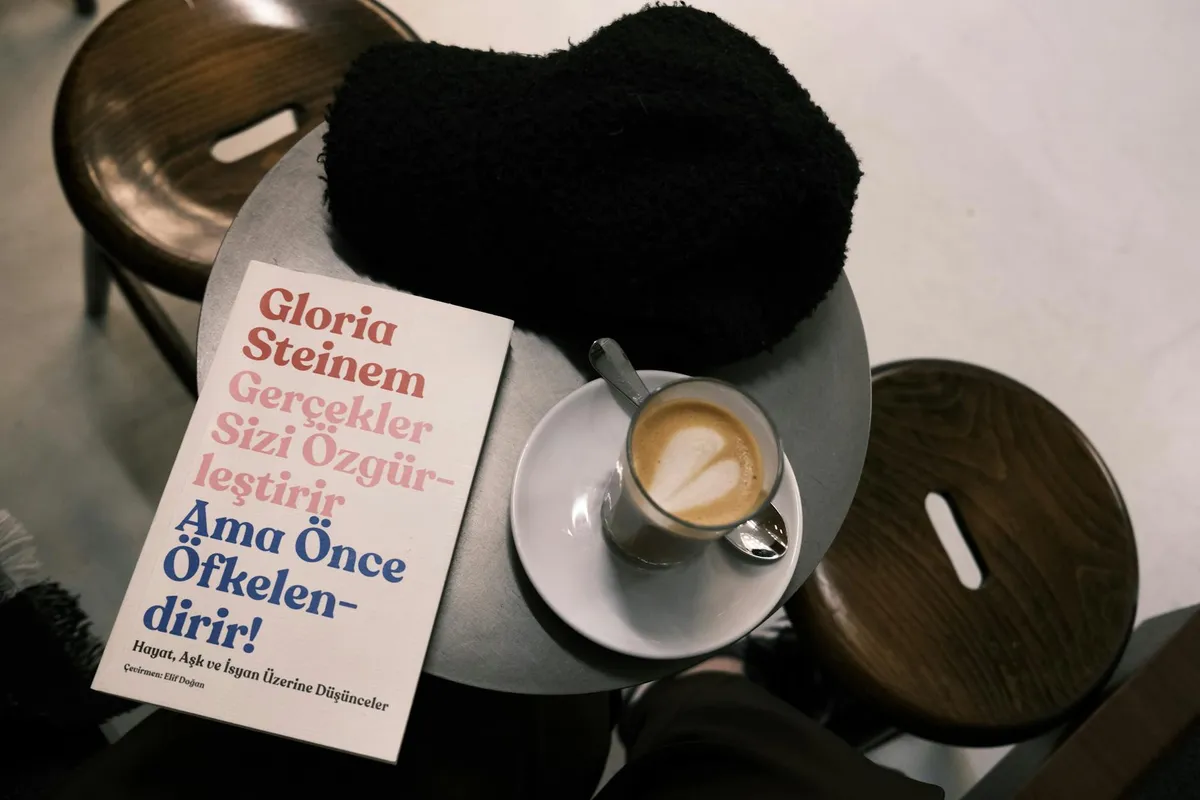 A philosophy book and notebook on a café table